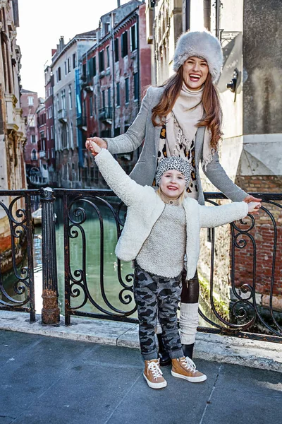 mother and daughter tourists in Venice having fun time
