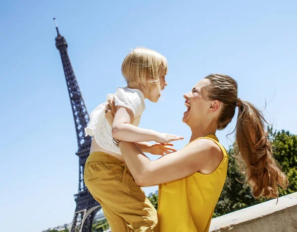 Having fun time near the world famous landmark in Paris. happy mother and child having fun time against Eiffel tower