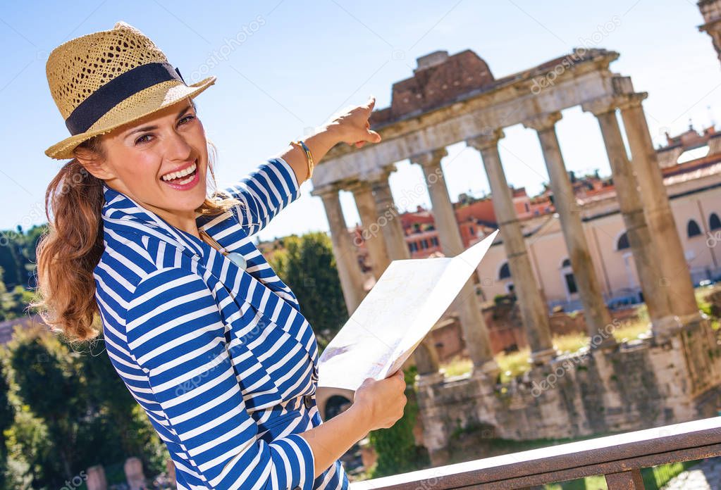 Roman Holiday. happy trendy traveller woman near Roman Forum in Rome, Italy holding map and pointing