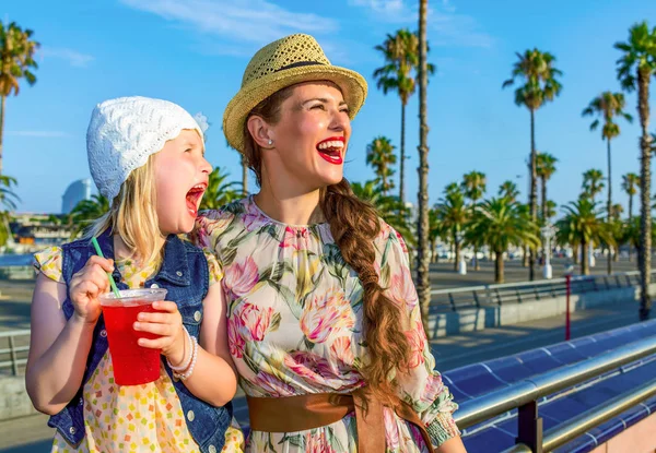 Smiling Trendy Mother Child Tourists Barcelona Spain Bright Red Beverage — Stock Photo, Image