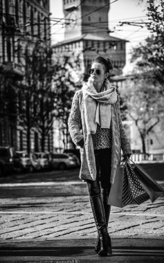 Tam uzunlukta portresi zarif gezgin kadın kürk ceket ve güneş gözlüğü mesafe içine bakarak ve ayakta Milan, İtalya