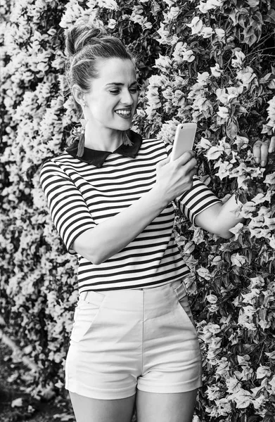 Šťastná Mladá Žena Šortky Pruhované Tričko Poblíž Květiny Pořízení Fotografie — Stock fotografie