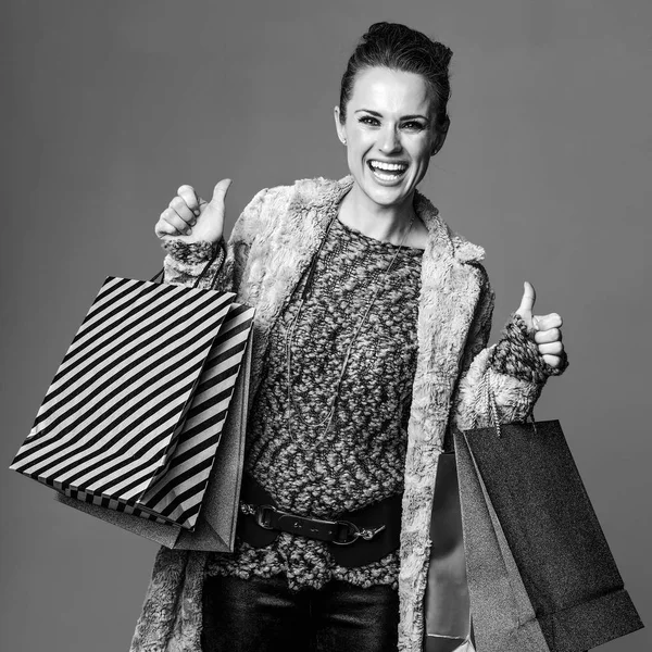 Portret Van Lachende Moderne Vrouw Winterjas Met Boodschappentassen Geïsoleerd Een — Stockfoto