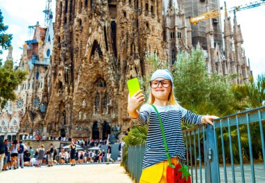 Barcelona - 10 Temmuz 2017: modern çocuk sarı şort ve selfie alarak cep telefonu ile çizgili gömlek-Barcelona, İspanya
