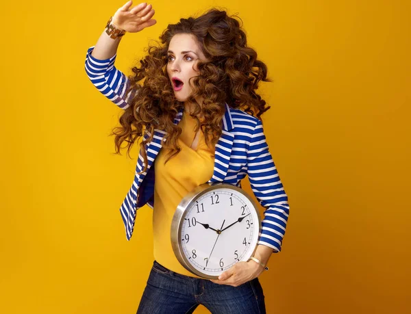 Surprised Stylish Woman Striped Jacket Yellow Background Clock Looking Distance — Stock Photo, Image