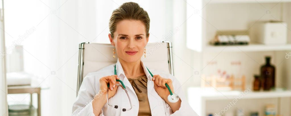 happy medical doctor woman sitting in office