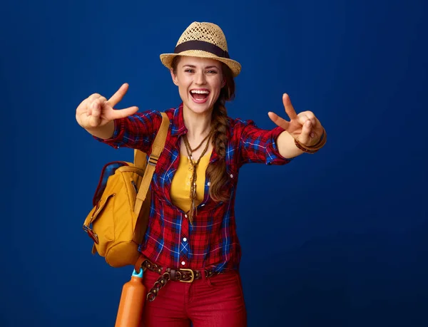 Happy Healthy Traveler Woman Backpack Showing Victory Gesture Blue Background — Stock Photo, Image