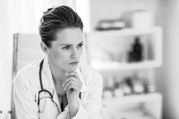 Portrait of thoughtful doctor woman in office