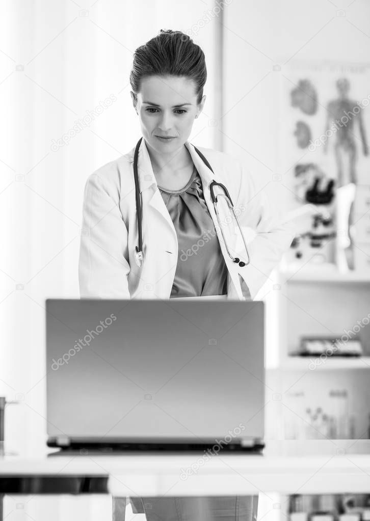 Medical doctor woman looking in laptop