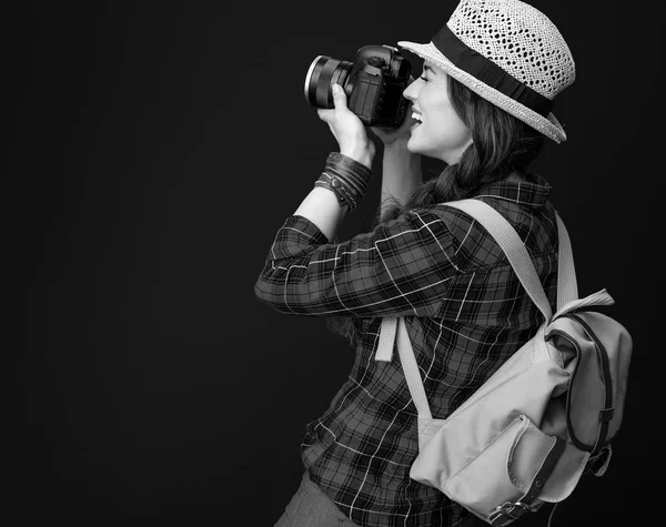 バックパックとデジタル一眼レフ カメラ撮影のアドベンチャー観光女性の笑みを浮かべてください — ストック写真