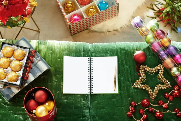 Caderno aberto com páginas em branco que colocam perto de ornamentos de Natal — Fotografia de Stock