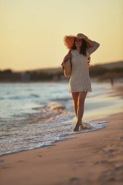 夕暮れの海岸でストレスフリータイムを楽しんでる幸せな女性 — ストック写真