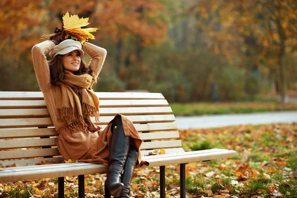 Relaxed elegant middle age woman with yellow leaves — 스톡 사진