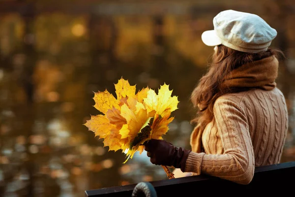 Stylish 40 year old woman with yellow leaves — Stock Photo, Image