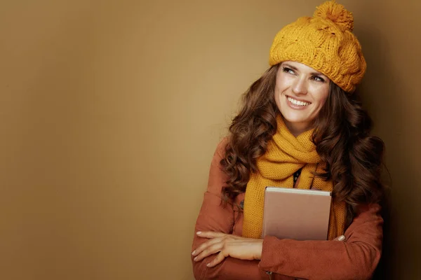 Happy woman looking at copy space while hugging book — Stock Photo, Image