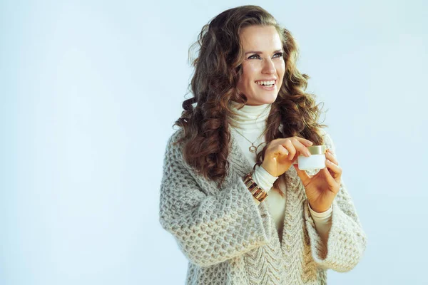 Щаслива елегантна домогосподарка тримає зимовий крем для обличчя — стокове фото