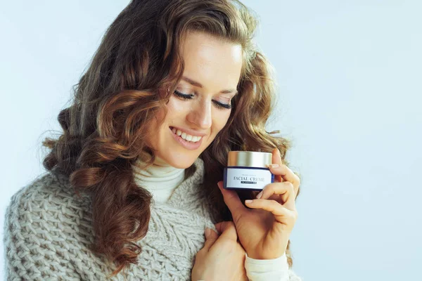 Woman using winter creme to protect skin from cold weather — ストック写真