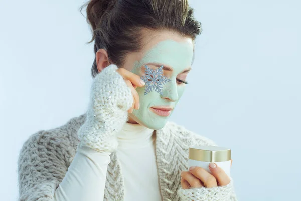 Hona med grön ansiktsmask med kosmetisk burk och snöflinga — Stockfoto