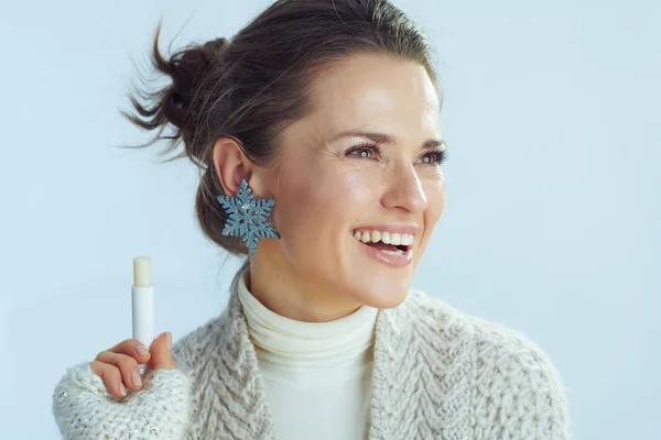 housewife with lip balm as winter lip care looking at copy space