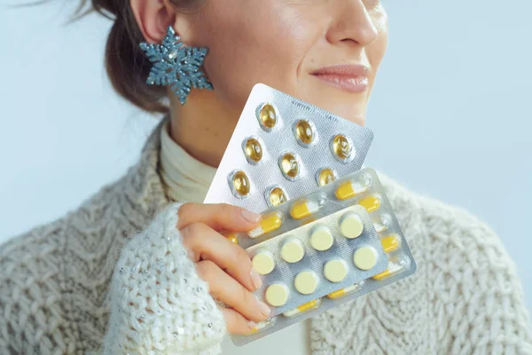 Closeup on happy housewife holding blister packs of vitamins — Stock Photo, Image