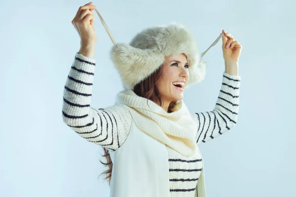 Cheerful modern woman isolated on winter light blue background — ストック写真