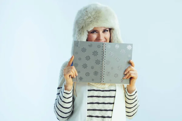 Happy trendy 40 years old woman hiding behind notebook — Stock Photo, Image