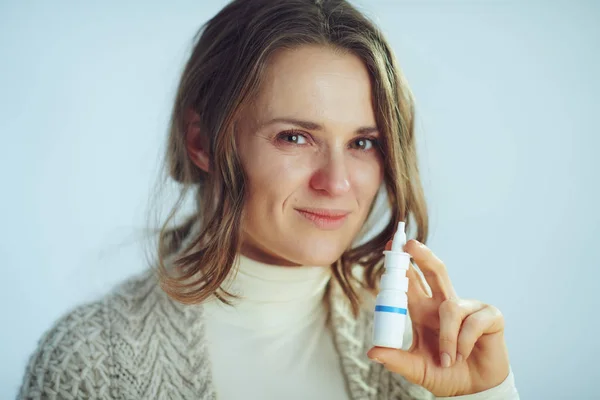 Sick modern housewife showing nasal spray — Stock Photo, Image
