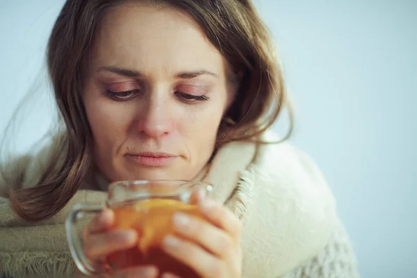 Sad sick modern woman drinking cup of tea — Stock Photo, Image