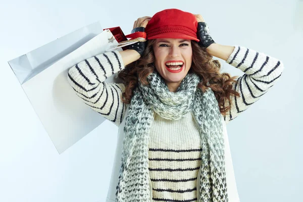 Cheerful trendy woman shopper on winter light blue background — 스톡 사진