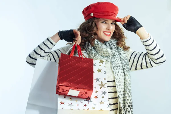 冬のライトブルーを背景にショッピングバッグを持つ女性 — ストック写真