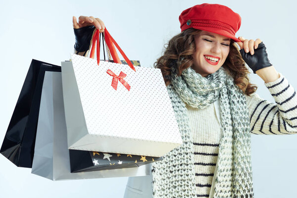 smiling modern middle age woman showing shopping bags