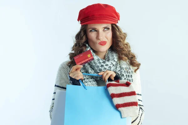Pensive elegant woman shopper with sweaters and credit card — 스톡 사진