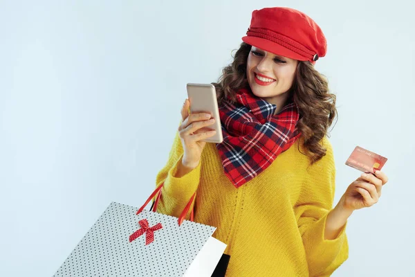 Smiling modern woman shopper and smartphone buying online — 스톡 사진