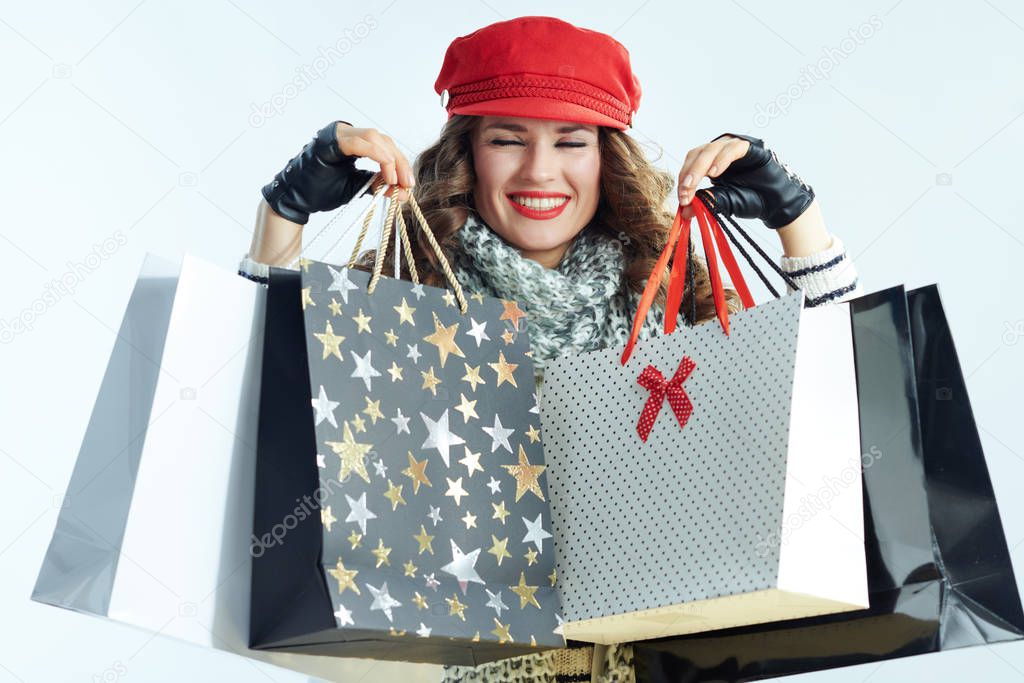 woman showing shopping bags on winter light blue background