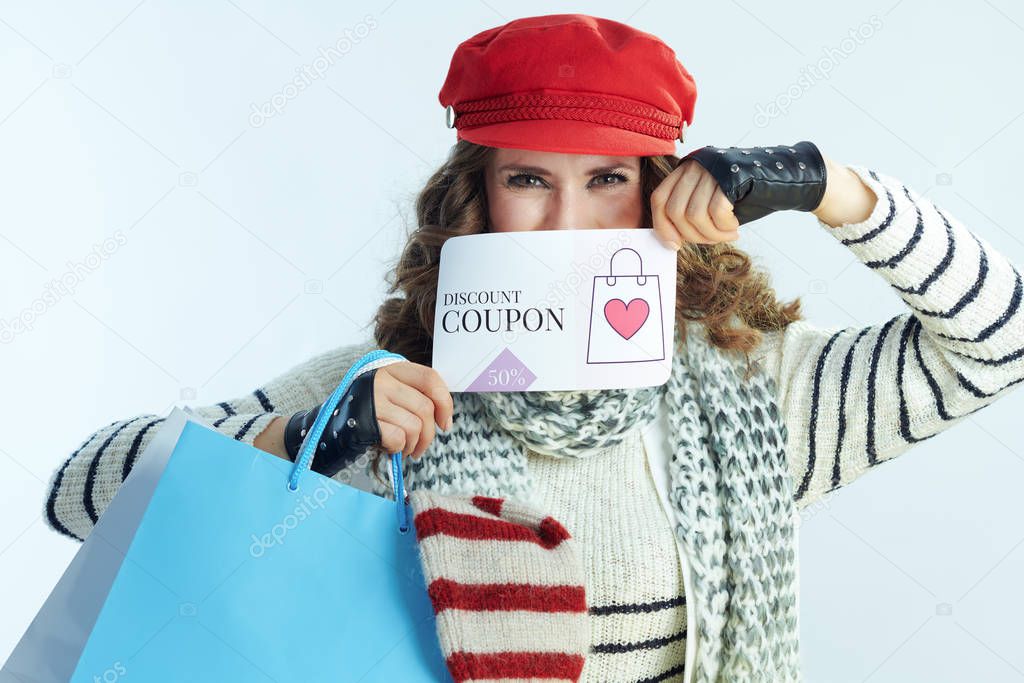trendy woman shopper with sweaters showing discount coupon