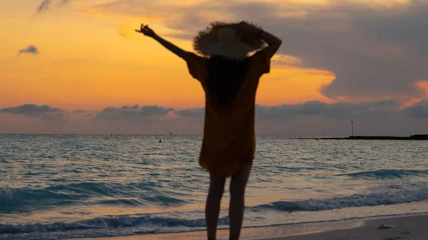 Fit woman in straw hat with raised arms rejoicing — 스톡 사진