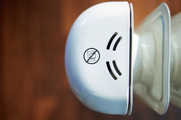 Closeup on radiator with sign do not dry clothes — Stock Photo, Image