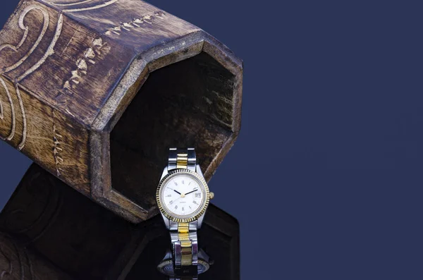 Wooden box and wrist watch reflection