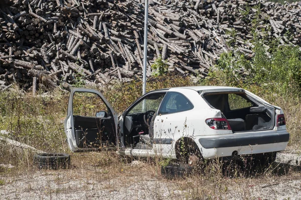 Stolen and abandoned car at big heat of firewood