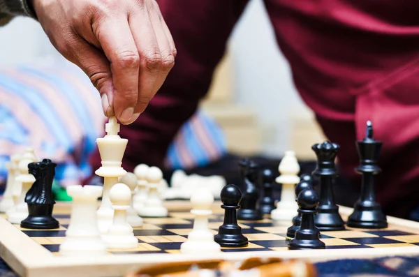 Mänsklig hand flytta en kung schackpjäs — Stockfoto