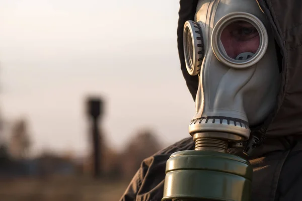 face in gas mask closeup in the background trumpet, threat of contamination or poisoning