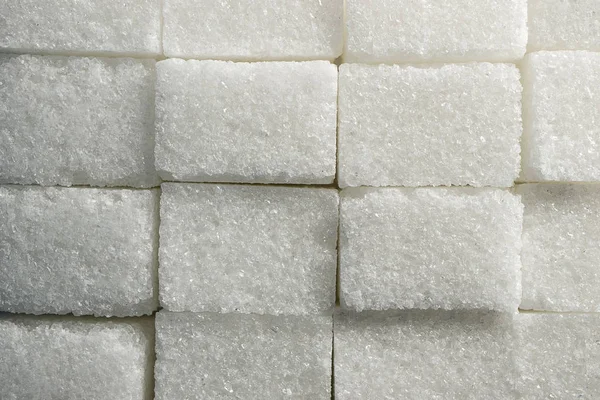 Consistenza di grumoso zucchero bianco mattoni di forma rettangolare impilati uno accanto all'altro — Foto Stock