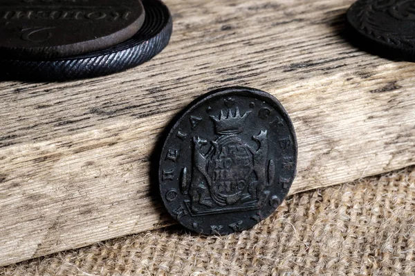 old copper coins on a wooden background, coins out of circulation