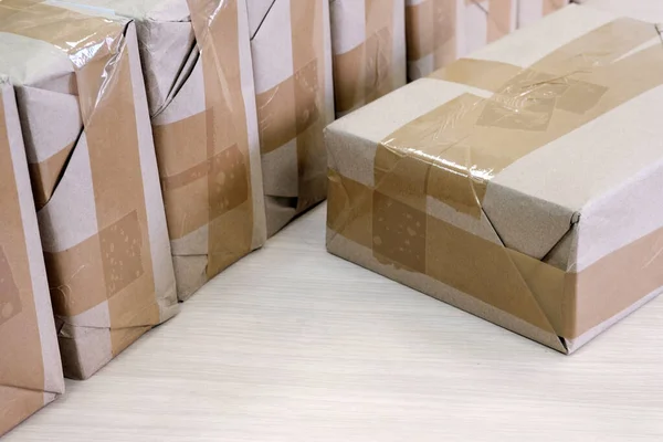 Packs with unknown contents are sealed with brown wrapping paper — Stock Photo, Image