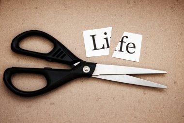 on a strip of paper it is written: it is cut with scissors. cut life into two halves sent in a box