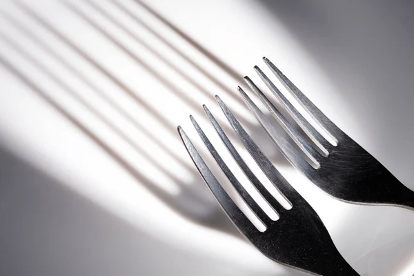 Two Forks Cast Shadow Teeth White Ceramic Surface Long Shadow — Stock Photo, Image