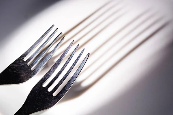 Abstraction Long Shadows Teeth Two Forks White Ceramic Surface Cutlery — Stock Photo, Image