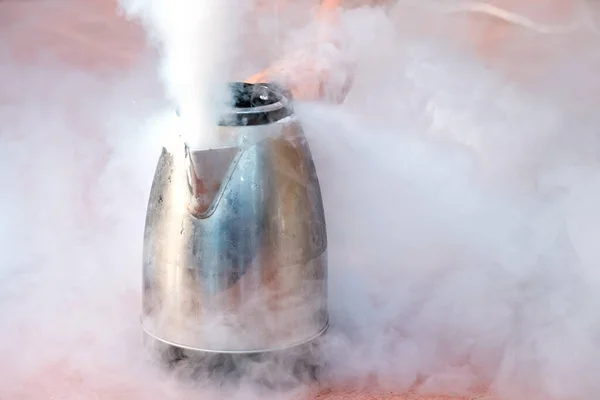 evaporating liquid nitrogen from a metal teapot all in clouds of steam. experiments with liquid nitrogen