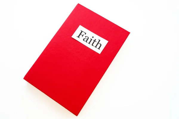 a book about faith in red on a white background. a story about faith or a story