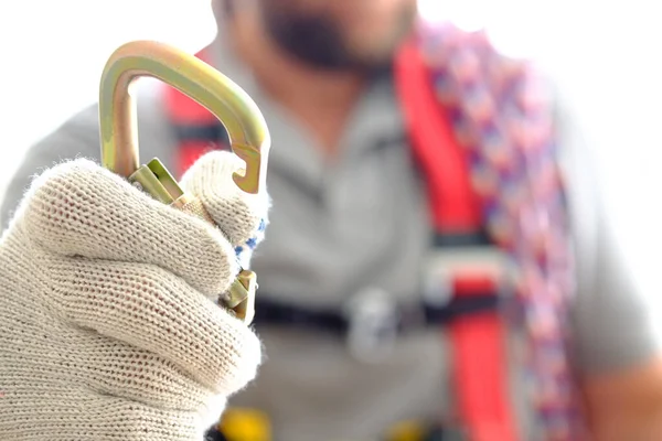 the arm with the open carabiner is extended by a latch to engage the system. works at the height of fall protection